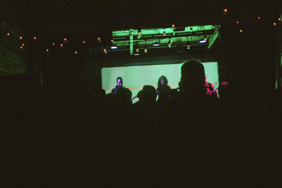 The crowd in silhouette against the lit stage