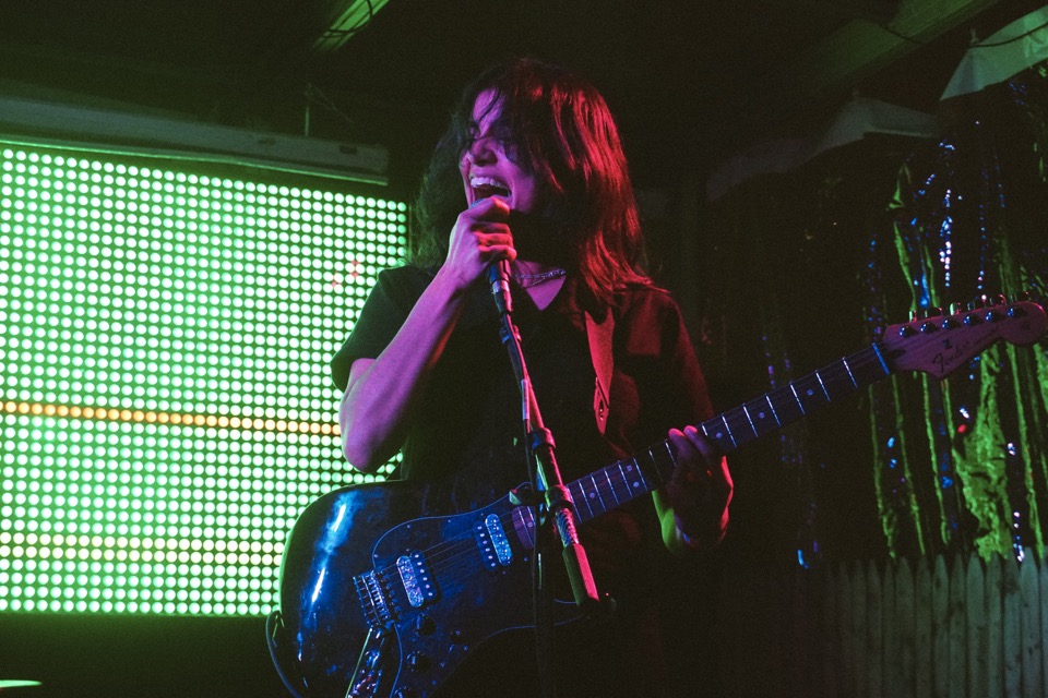 A singer with a blue guitar
