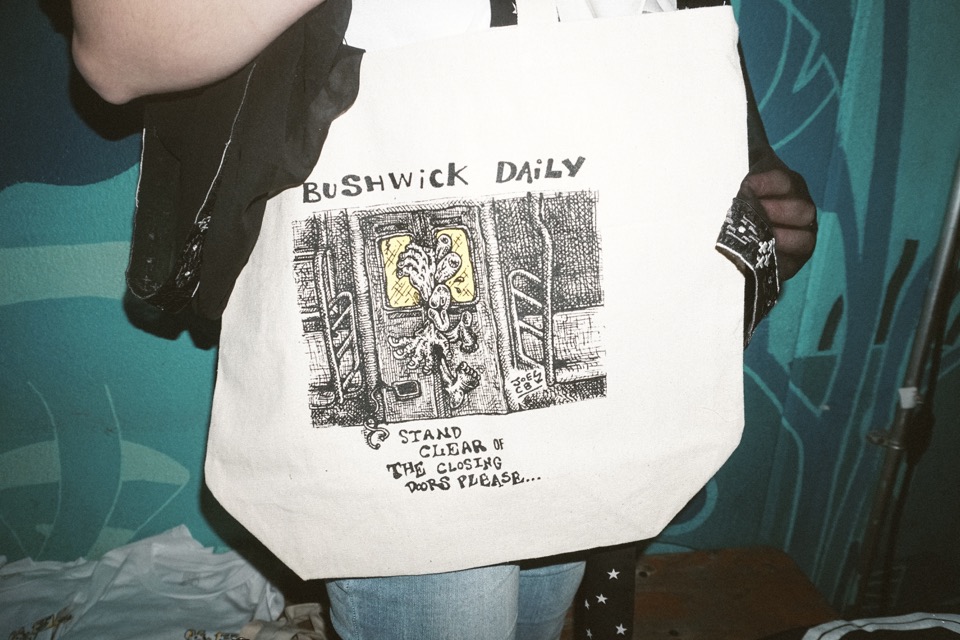 A Bushwick Daily tote bag with a drawing of subway doors