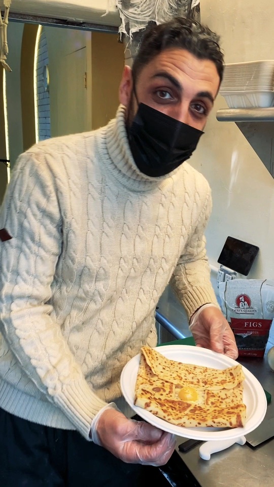 Eric Violino holding a plated crêpe